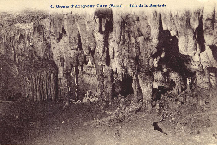Limestone cliffs and cave entrances of Arcy-sur-Cure above the river Cure
