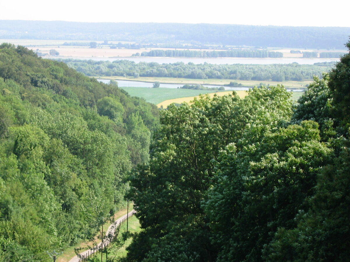 View of the Seine valley, a meander of the river fringed by wooded slopes and meadows